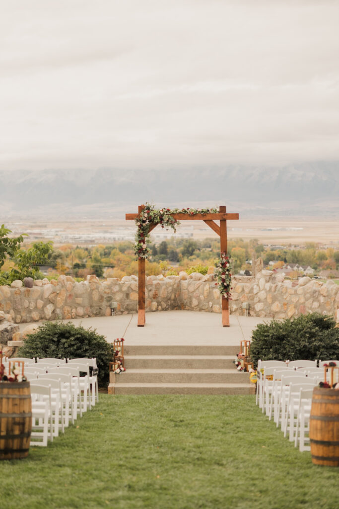 Wedding ceremony setup with florals around the wedding arch at Mt. Naomi Vineyards in Northern Utah.