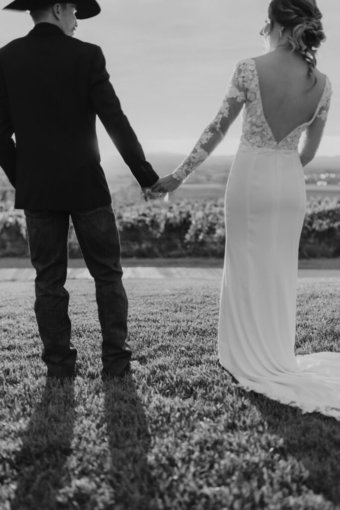 Bride and Groom holding hands at Mt. Naomi Vineyards in Hyde Park, Utah