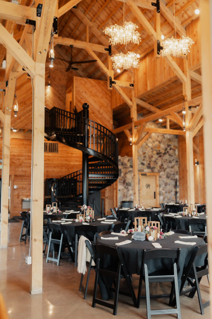 Photo featuring the spiral staircase and chandeliers inside Mt. Naomi Vineyards in Hyde Park, Utah one of the top 8 wedding venues in Northern Utah