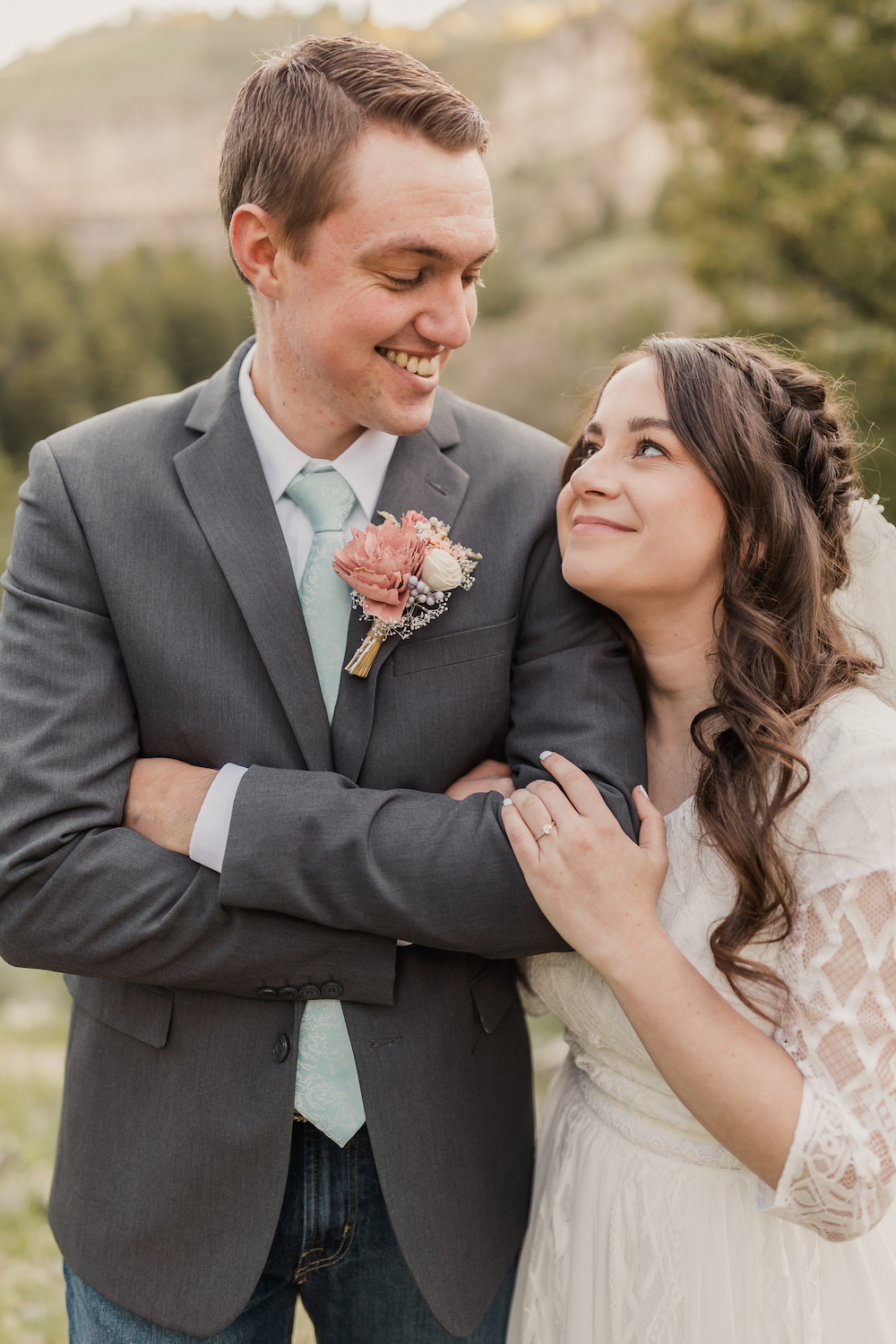 Getting Comfortable In Front of the Camera For Your Wedding Day: Bride rests her head against groom's shoulder as they smile at each other.