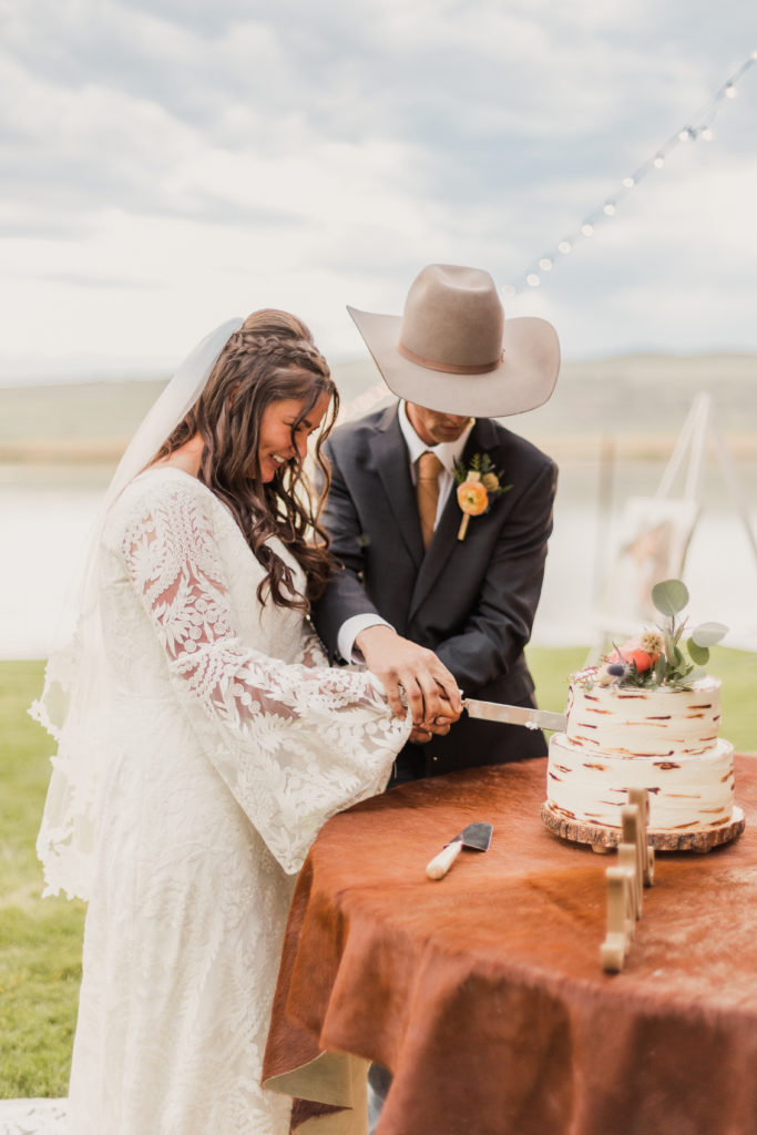 Couple cutting their cake together during the reception in Utah