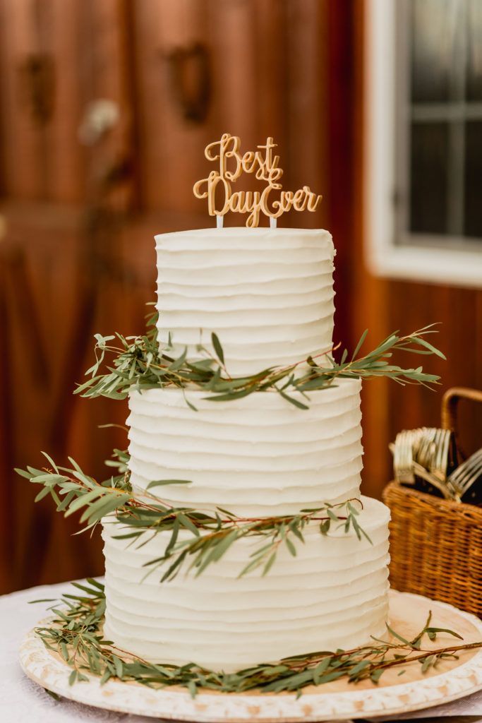 What to look for when hiring a Utah Western Wedding Photographer. Three-tier wedding cake with topper that reads Best Day Ever.