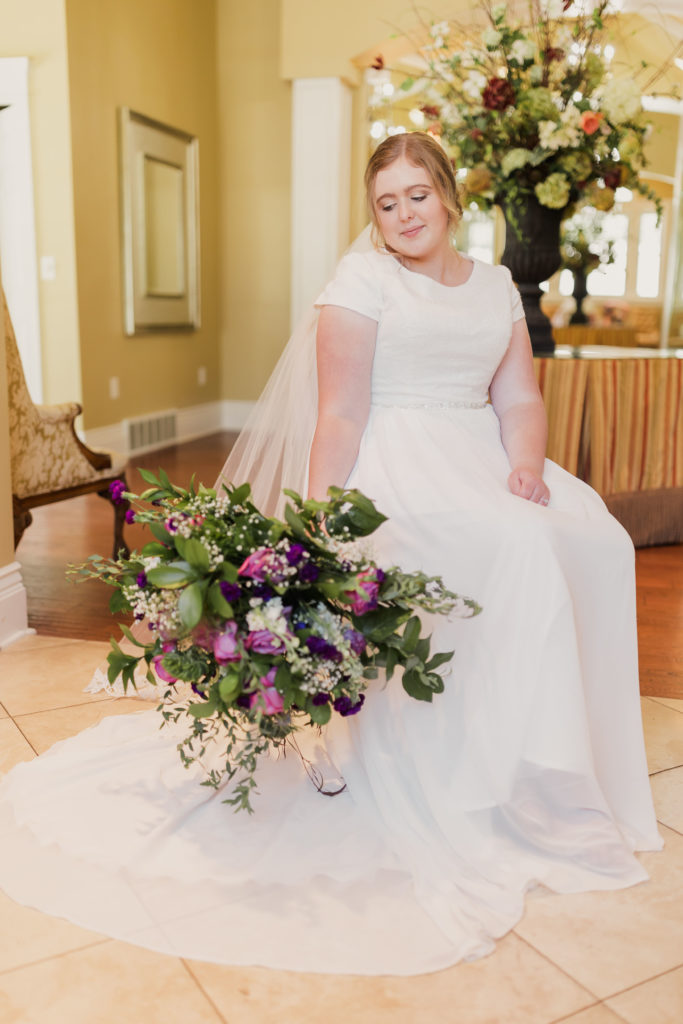 Bride posing for a bridal shot in her getting ready room, taken by Utah wedding photographer Robin Kunzler