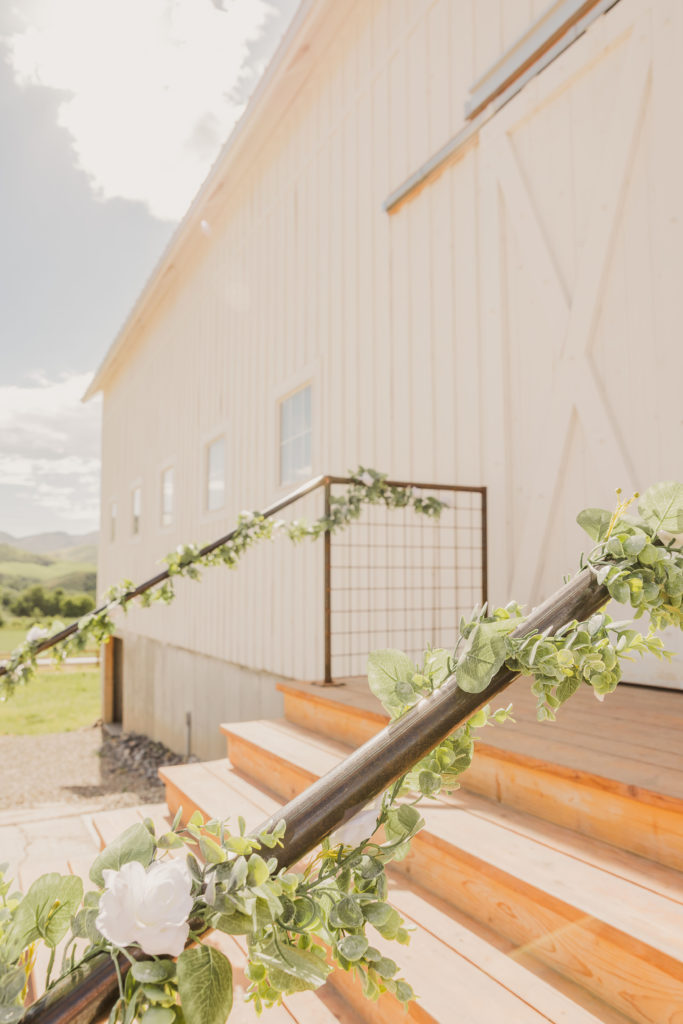 The Top 8 Wedding Venues in Northern Utah: Railings outside The Barn in Old Paradise with vines and flowers on them.