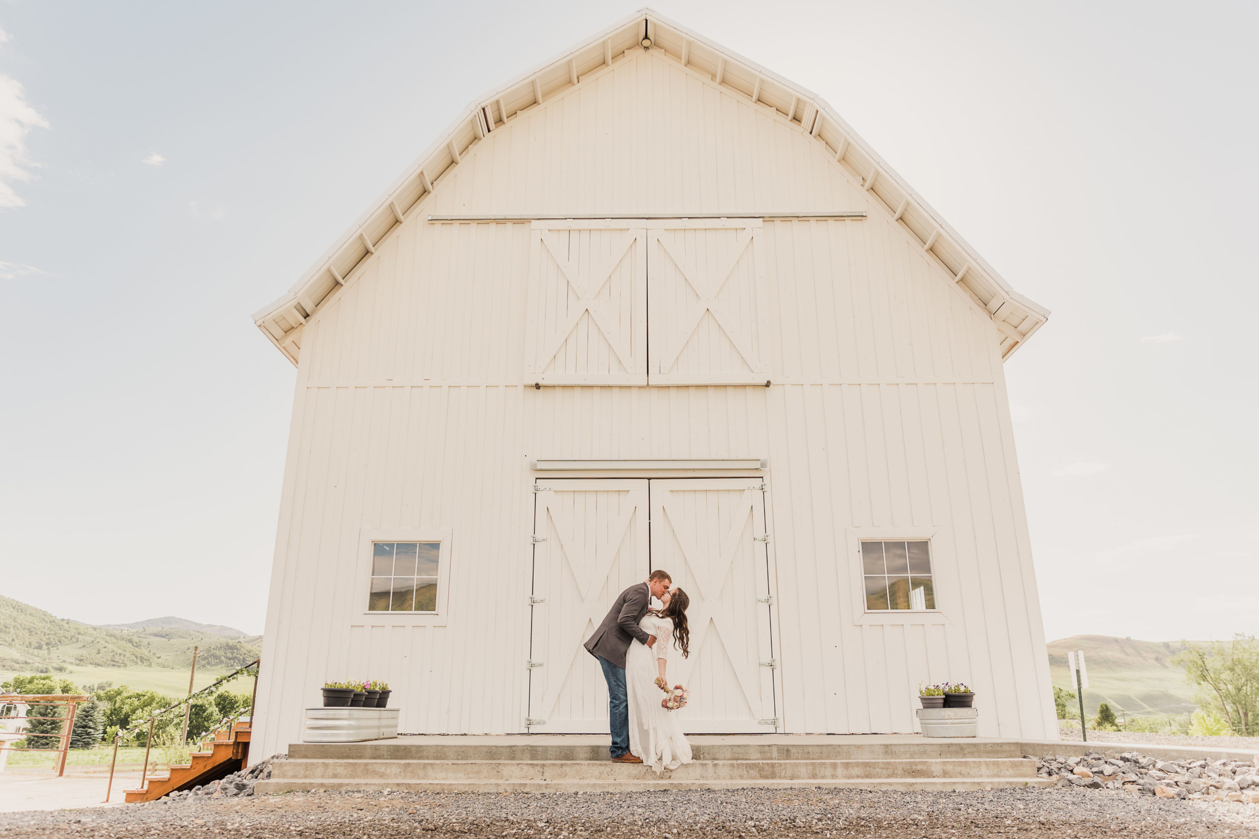 Bride and groom kissing outside the Old Paradise, one of the top 8 wedding venues in Northern Utah