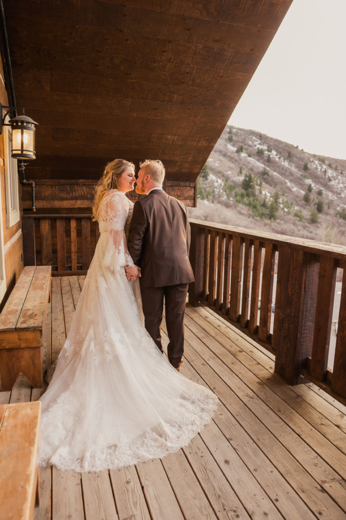 Bride and groom leaning in for a kiss during their wedding shoot at Cherry Peak Ski Resort