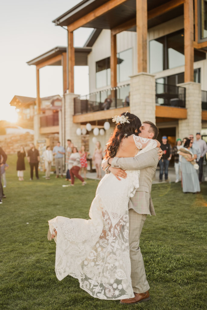 Groom lifts bride up as they share a kiss during their wedding shoot with Utah wedding photographer Robin Kunzler