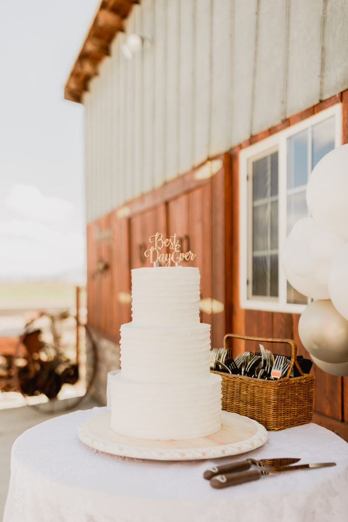 The Top 8 Wedding Venues in Nother Utah. Three tier wedding cake with cake topper that reads Best Day Ever.