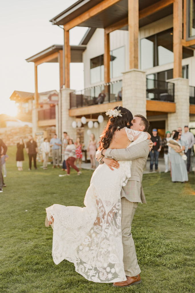 Groom lifts bride up as they share a kiss during their wedding shoot with Utah wedding photographer Robin Kunzler