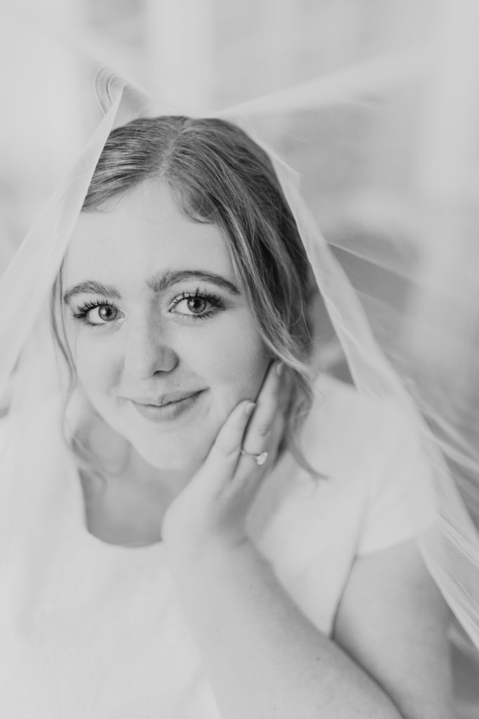 Bride posing for a bridal shot in her getting ready room, taken by Utah wedding photographer Robin Kunzler